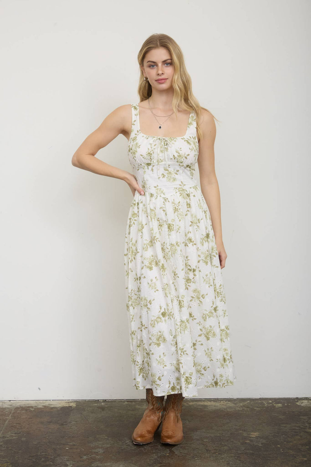 Woman wearing a floral dress against a plain background