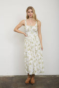 Woman wearing a floral dress against a plain background
