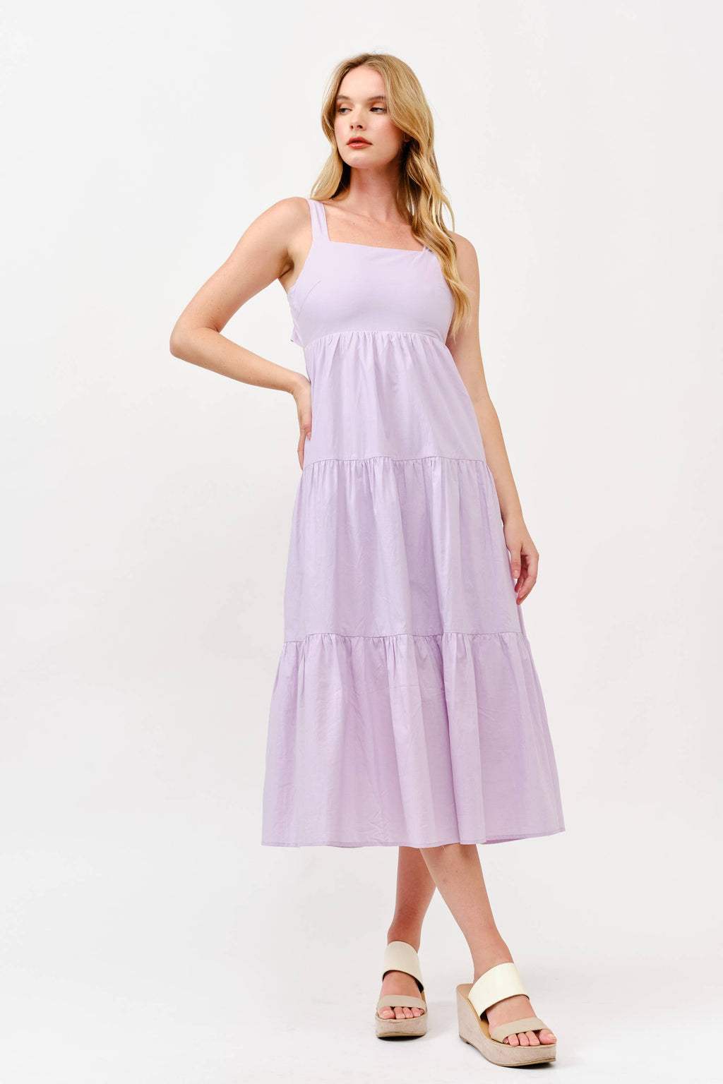 Woman wearing a light purple dress on a white background